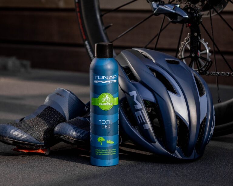 Textile Deo, Bicycle Helmet & Shoes, and rear wheel of bike in the background
